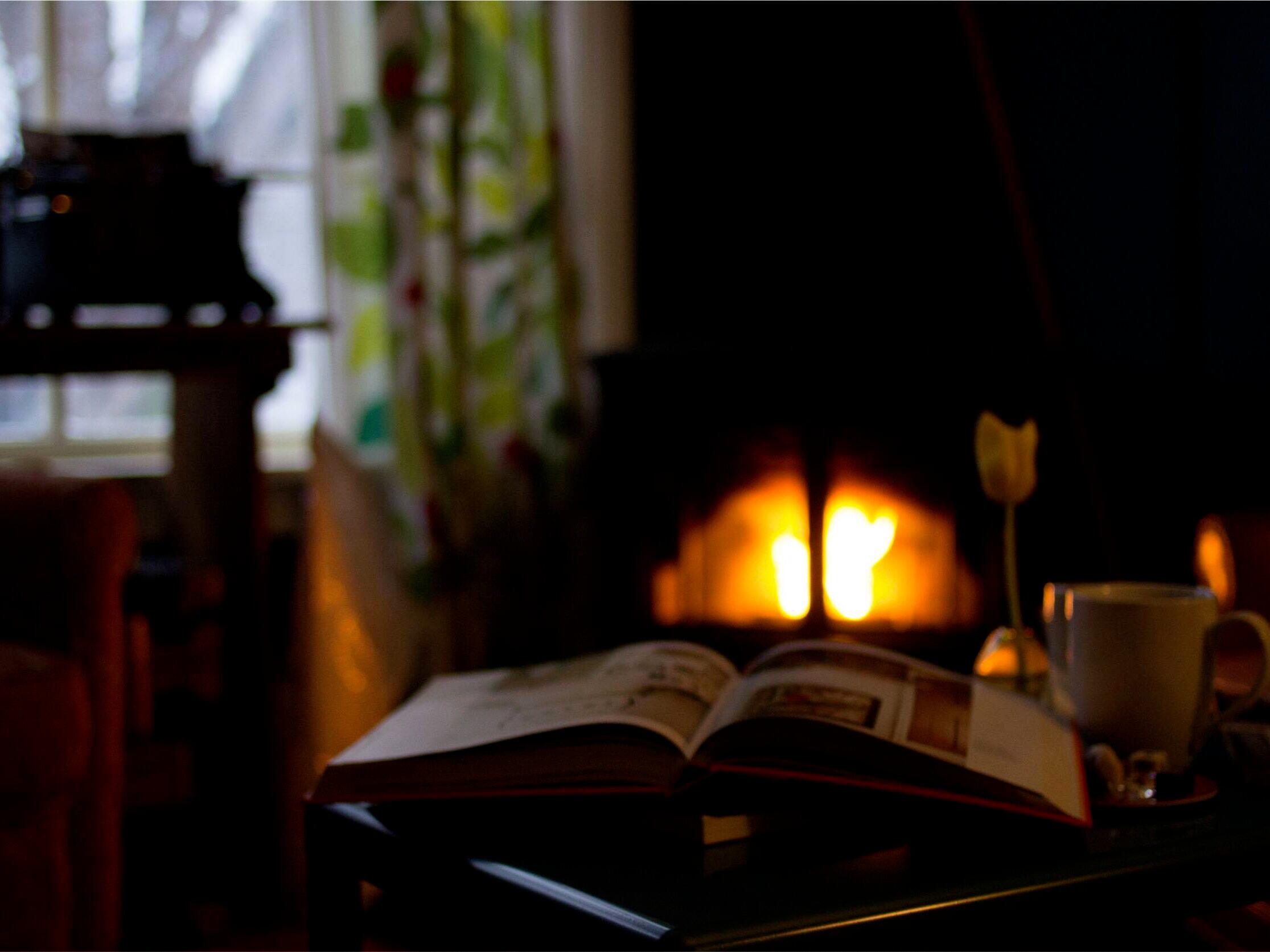 open book behind a cozy fireplace